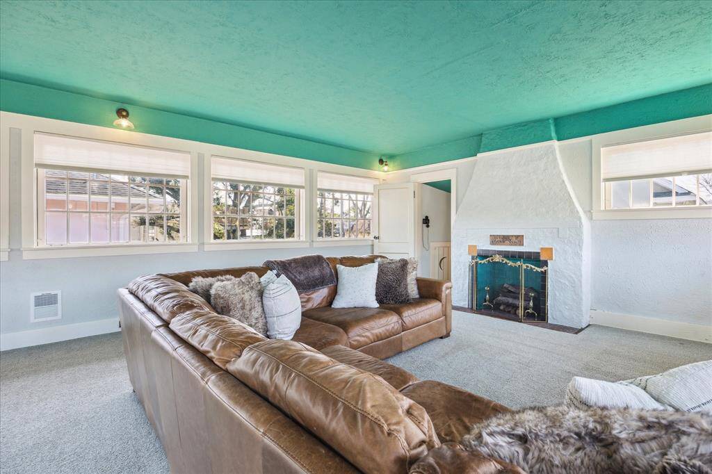 The upstairs ballroom has been divided into a living space and bedroom. The living space shows the fireplace and bathroom.