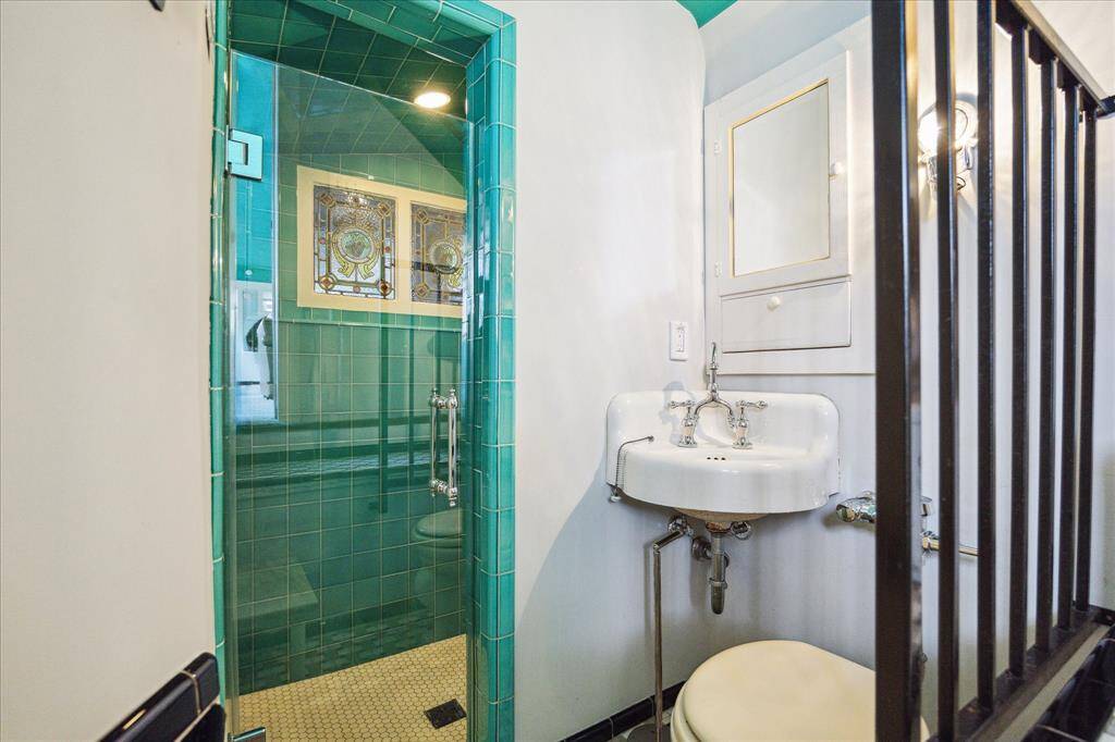 The bathroom features and large walk-in shower. The sink is original from 1925 when the upstairs was added onto the house.