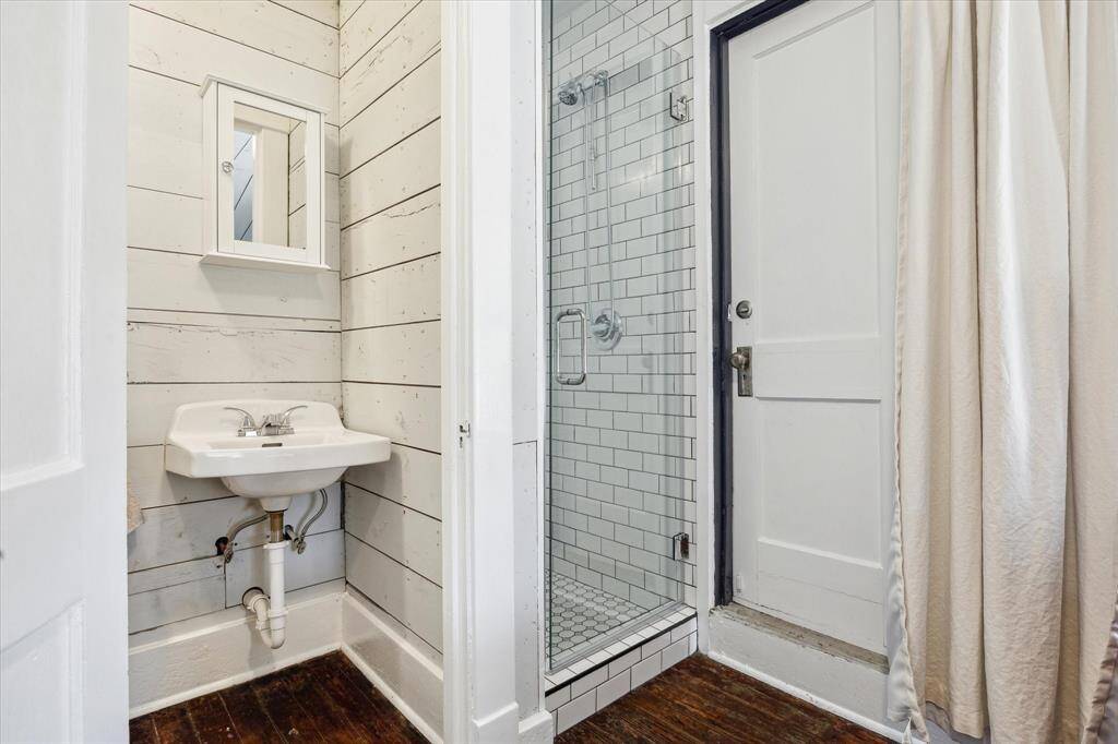 Water closet, shower and entry door.