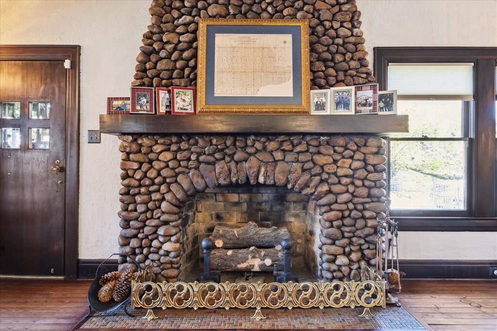 The stone gas fireplace with it's oversized wooden mantle and tile hearth are just a few of the charming historic features. The stones come from the ballast of ship from the Houston Ship Channel in 1920.