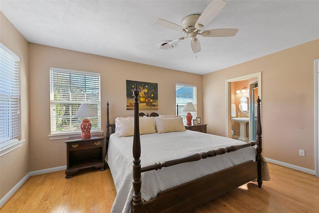 The primary retreat features a ceiling fan, hardwood floors, ensuite bath and huge walk in closet.