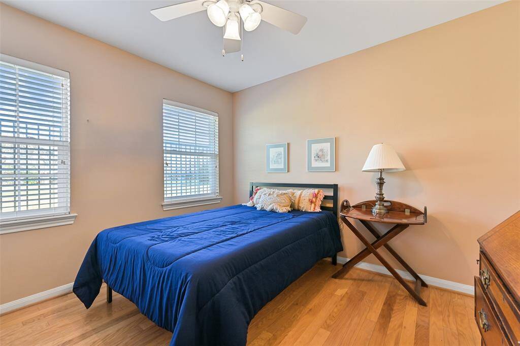 All bedrooms have ceiling fans, hardwood floors, and neutral paint.