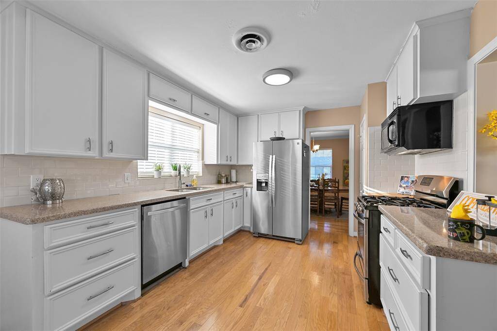 Create culinary delights in the well-appointed kitchen featuring  white cabinets (cabinet doors, hardware and lower cabinets replaced (2017), durable Sillstone countertops, stainless steel appliances, gas stove plus a pantry.