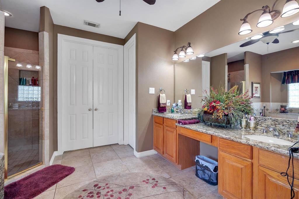 Primary Bathroom featuring double sink, vanity and walk-in closet