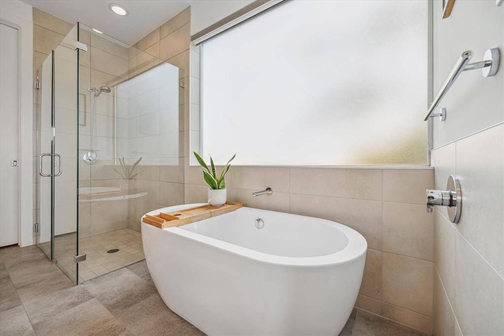 Freestanding soaking tub and separate walk-in shower.