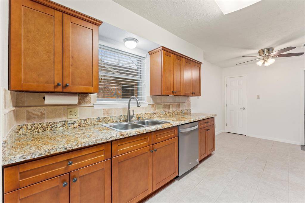 Granite countertops offer plenty of space for meal prep.