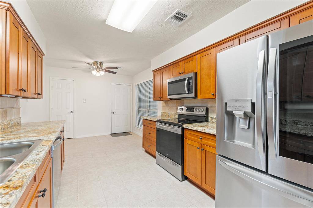 The kitchen is equipped with a pantry and plenty of storage.