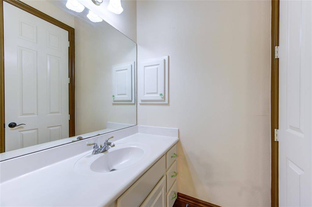 This is a spacious covered balcony with a ceiling fan, offering a view of the surrounding greenery and neighborhood. Perfect for outdoor relaxation and entertainment.