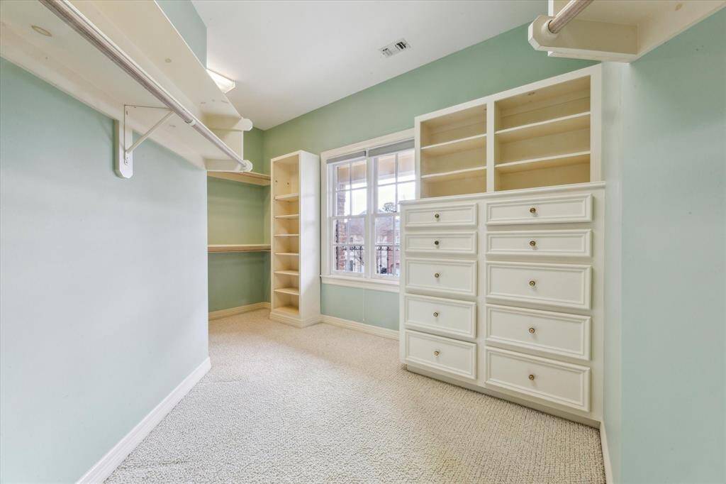 1 of 2 primary closets, this one gets the benefit of natural light and numerous built-ins.  There is a separate walk-in cedar closet around the corner to the left.