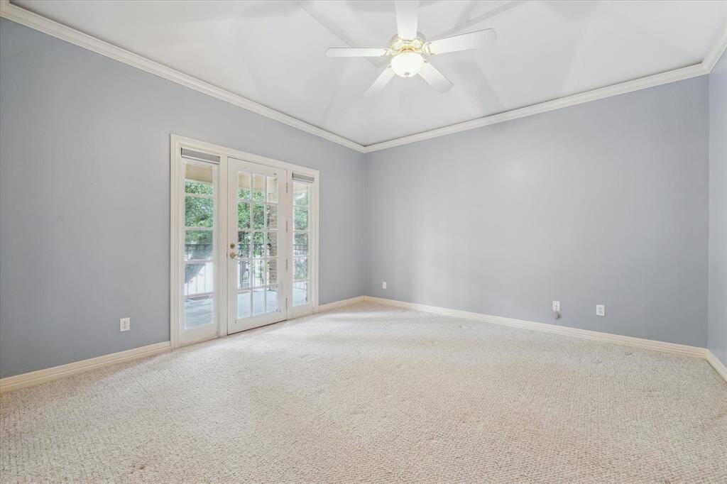 Secondary bedroom with high ceiling, en-suite bath, walk-in closet, private balcony access.  The two secondary bedrooms are well-separated from the primary suite, offering privacy for both family and guests.