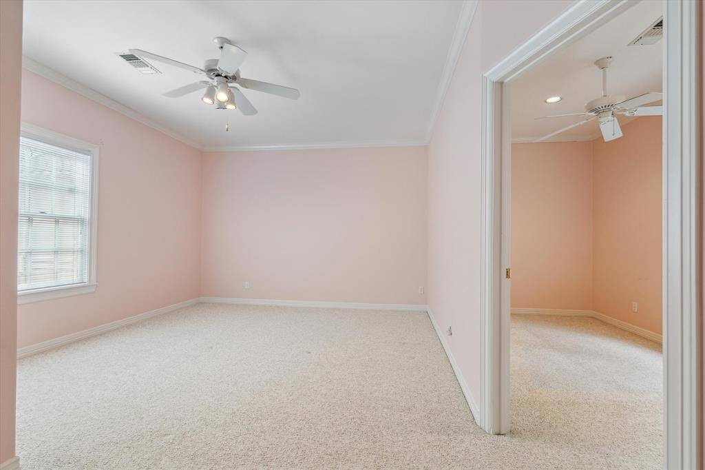 The second of the two secondary bedrooms has an adjoining flex room which can be utilized as a sitting area, workout space or play area.