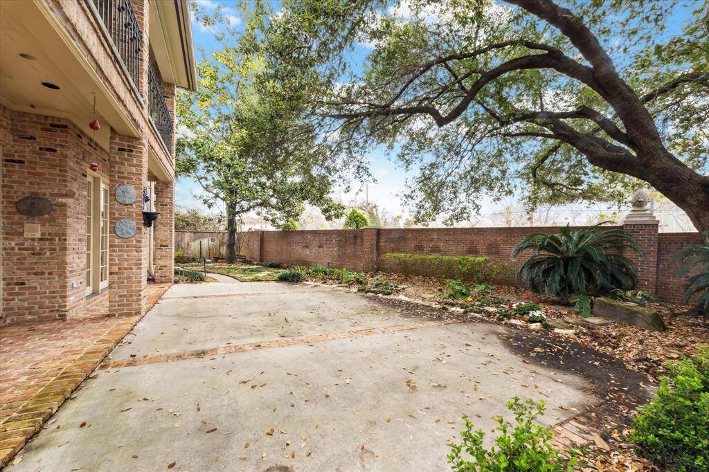 Large patio and yard area, shaded by mature trees, is great for both entertaining and relaxing.