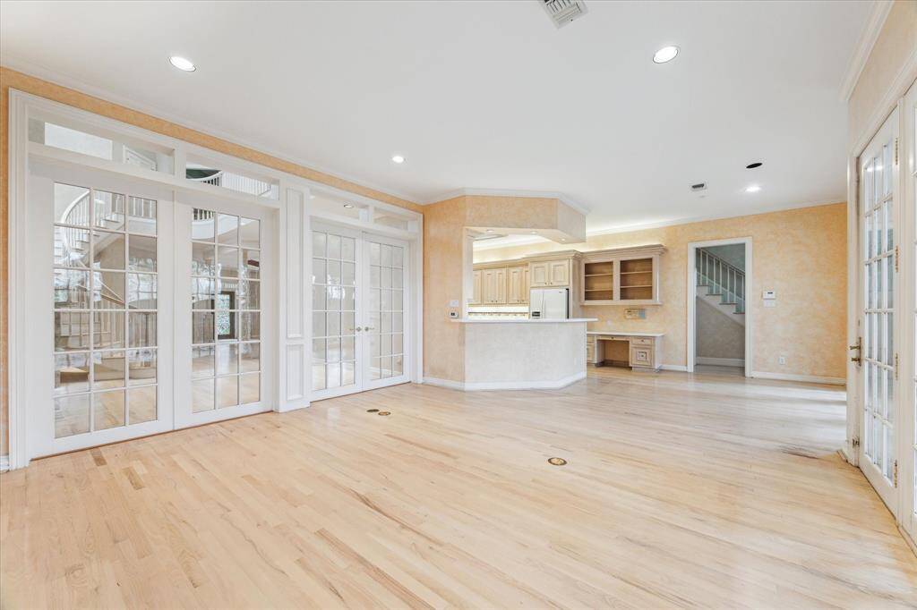 The inviting family room has a wall of french doors allowing it to be separated from the formal living and dining.   area.