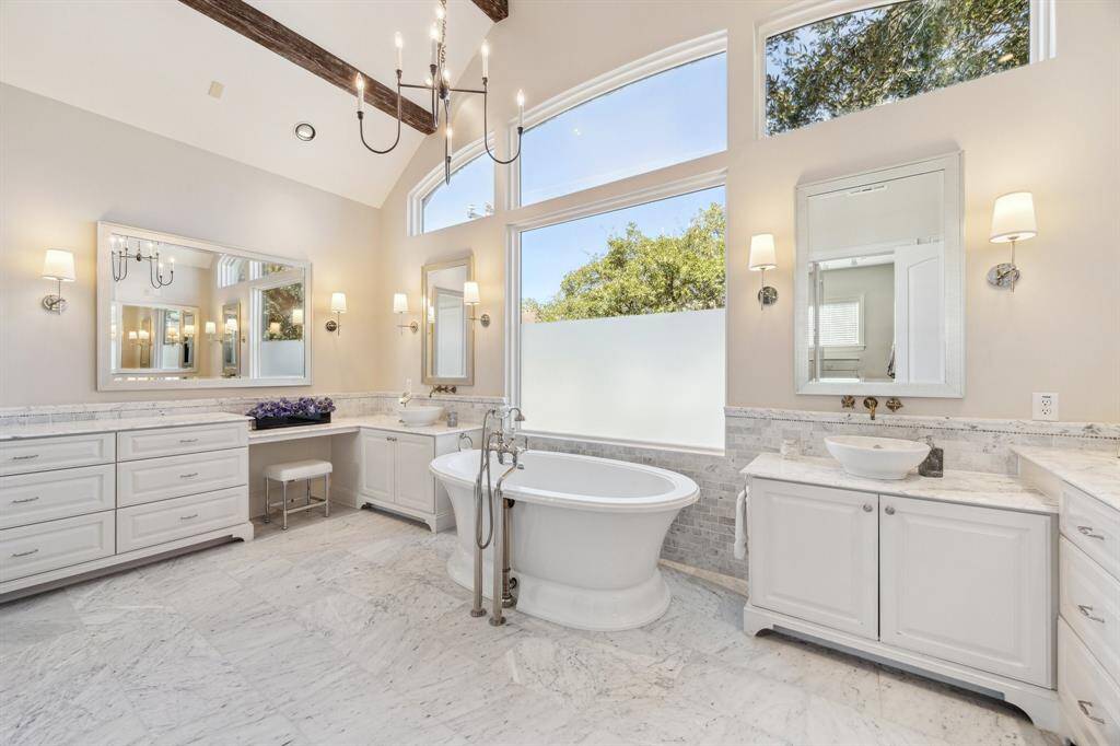 Spacious, sumptuously appointed, marble-clad primary bath with barrel vaulted beamed ceiling, deep soaking tub, two vanities, built-in seated makeup vanity area, northern exposure, two generous walk-in closets, water closet and large walk-in shower. Relax, soak, enjoy, and repeat.