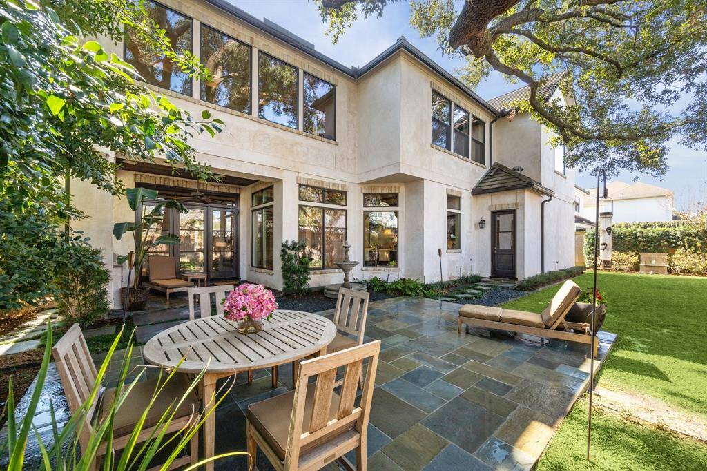 The perfect city oasis with large slate deck, mature specimen plants, two trickling water features and dramatic landscape illumination under a massive oak.  The perfect place for al fresco dining day or night.