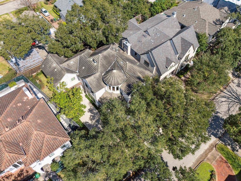 The home sits on a generous lot under a canopy of ancient oaks, just blocks from Memorial Park.