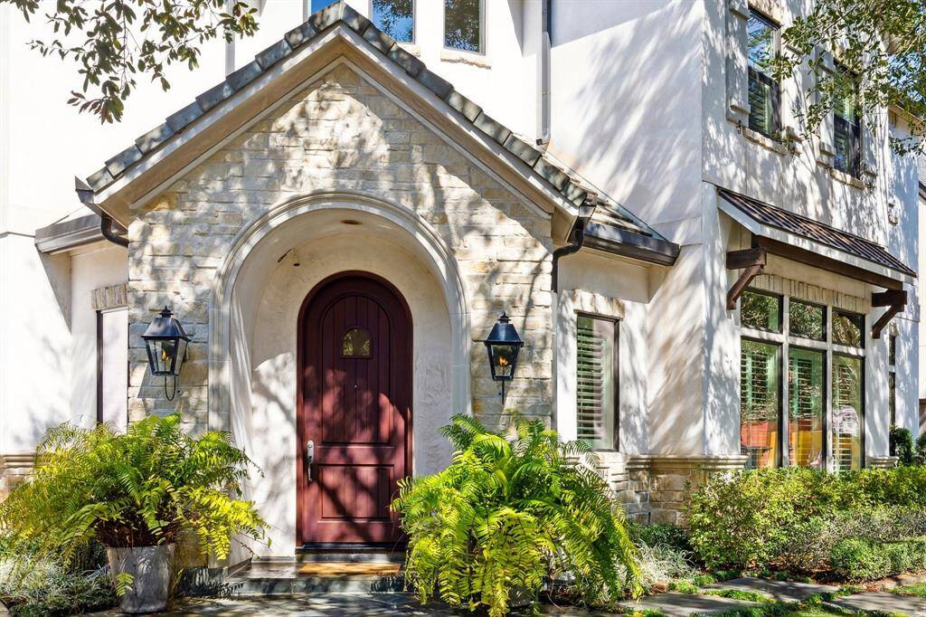 Gorgeous stucco, slate surfaced, warm, welcoming front entry flanked by stone-clad facade and handsome gas lanterns.