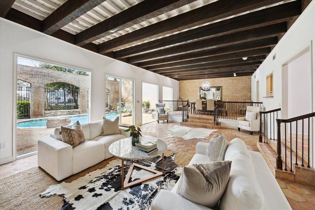 Expansive living and dining area with a cozy fireplace view.