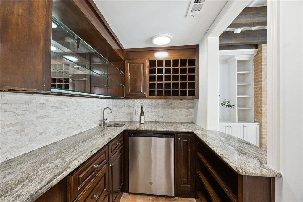 Entertain with ease using the sleek wet bar, complete with a refrigerator and wine storage.