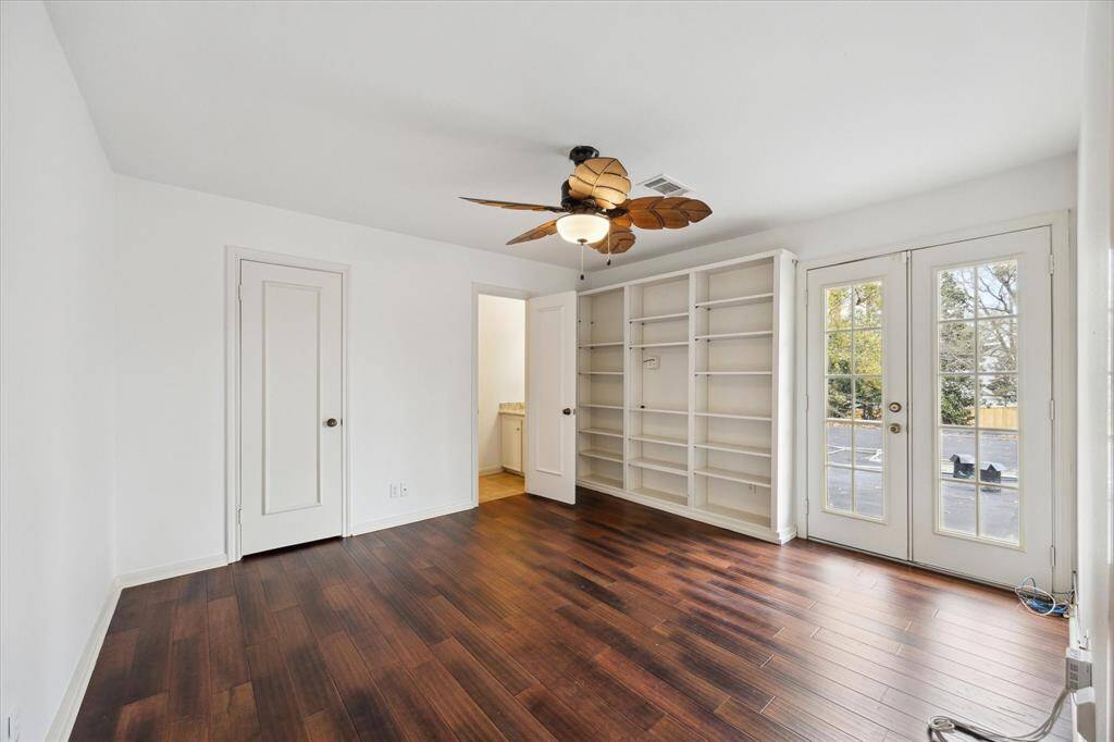 Upstairs space ideal for a bedroom or office, featuring convenient built-ins.