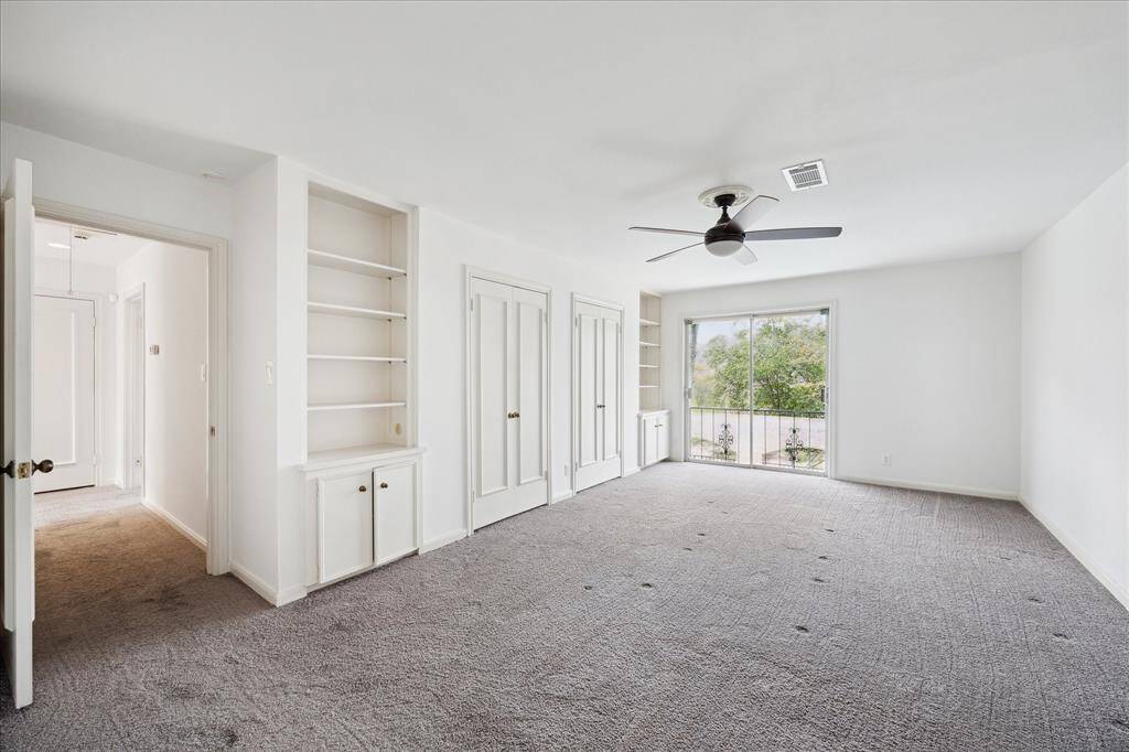 Discover serenity in the second bedroom, featuring stunning views of the bayou and lush, mature landscaping.