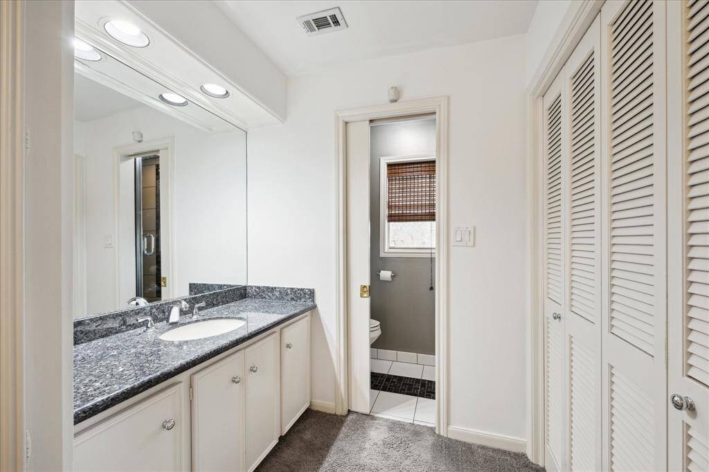 Spacious primary bathroom featuring dual showers, toilets, and vanities for ultimate convenience and privacy.