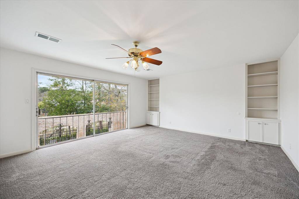 The primary bedroom offers serene views of the pool, bayou, and lush greenery.