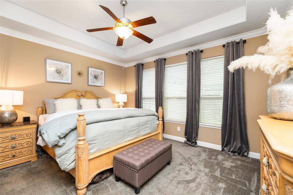 The Primary Bedroom has a tray ceiling and plush carpet