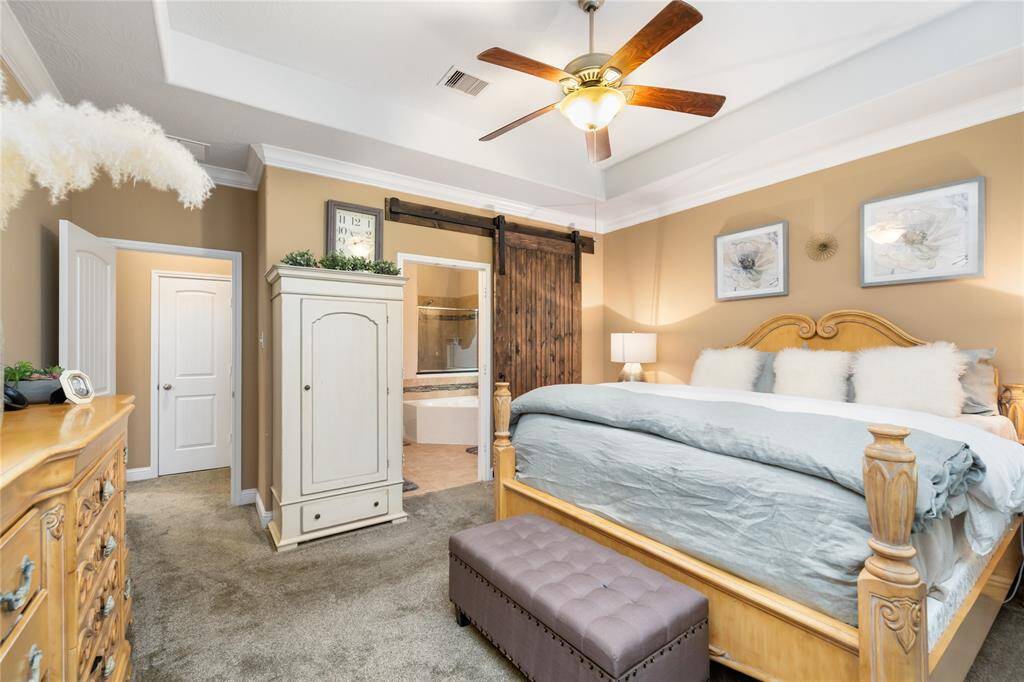 The en-suite bathroom is through the barn door
