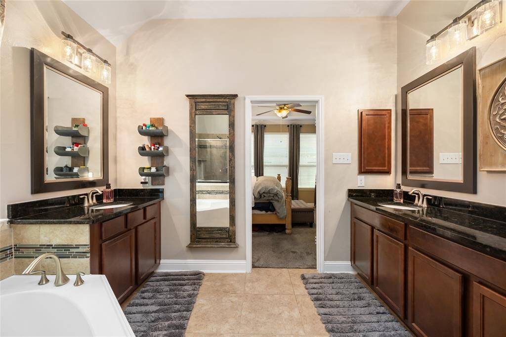 The dual vanities offer ample storage and counter space