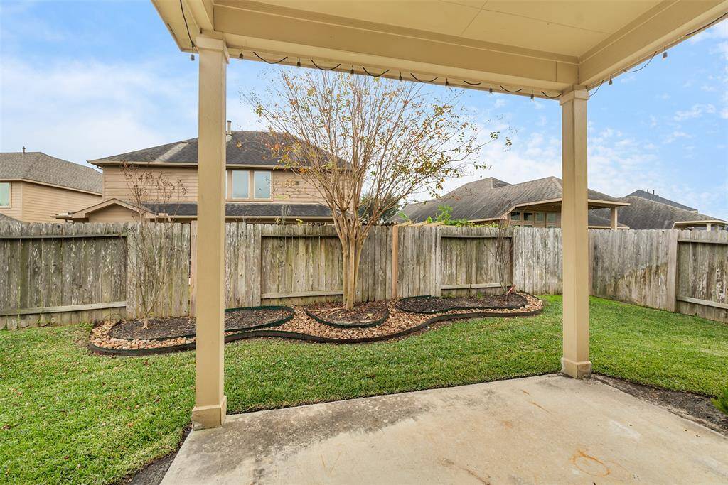The covered patio is perfect for setting up outdoor seating or a grill