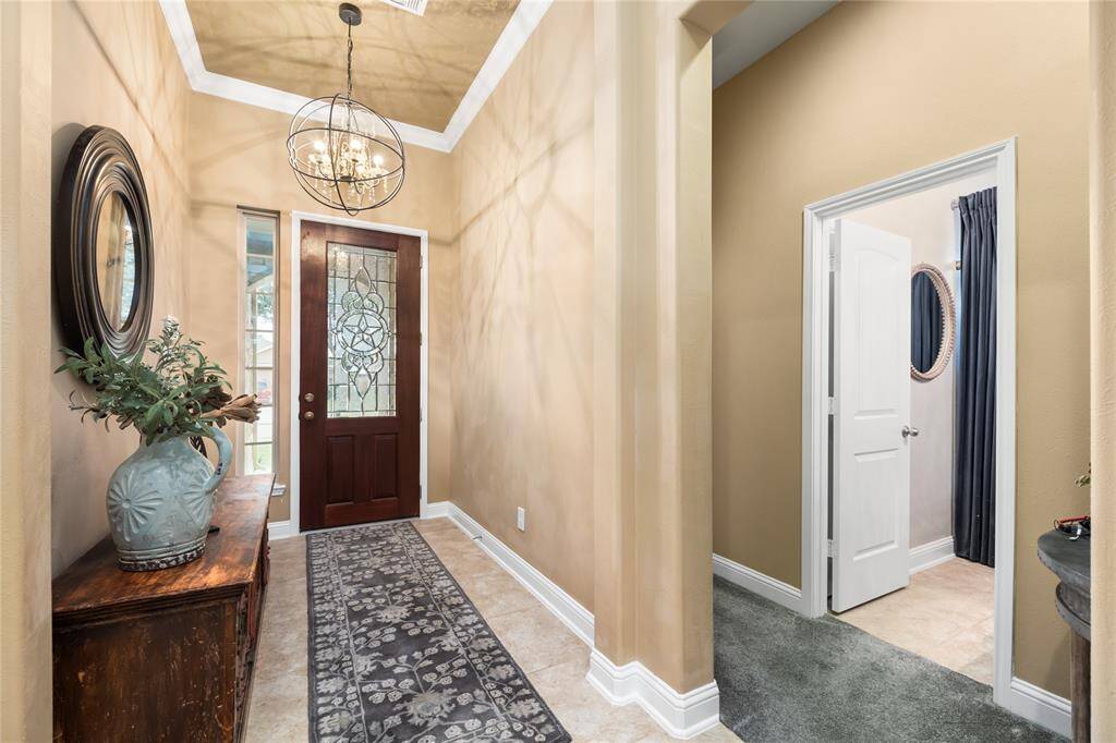 The entry is illuminated by a chic chandelier