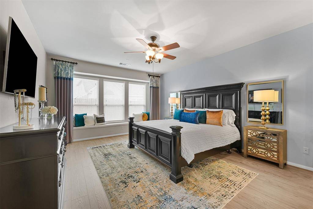 The primary bedroom is a true retreat, offering a peaceful escape at the end of the day. Imagine curling up with a good book on the cozy window bench and unwinding in this serene space designed for ultimate relaxation.