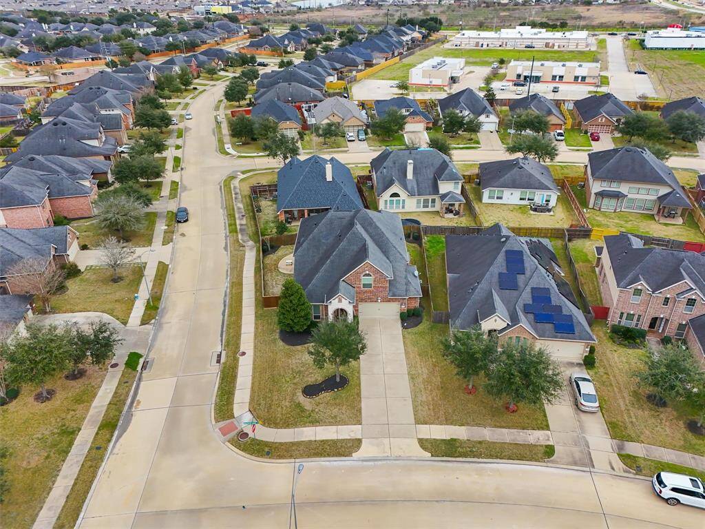 A bird's-eye view of this corner lot showcases the impressive extra-long driveway, offering plenty of space for parking or play.