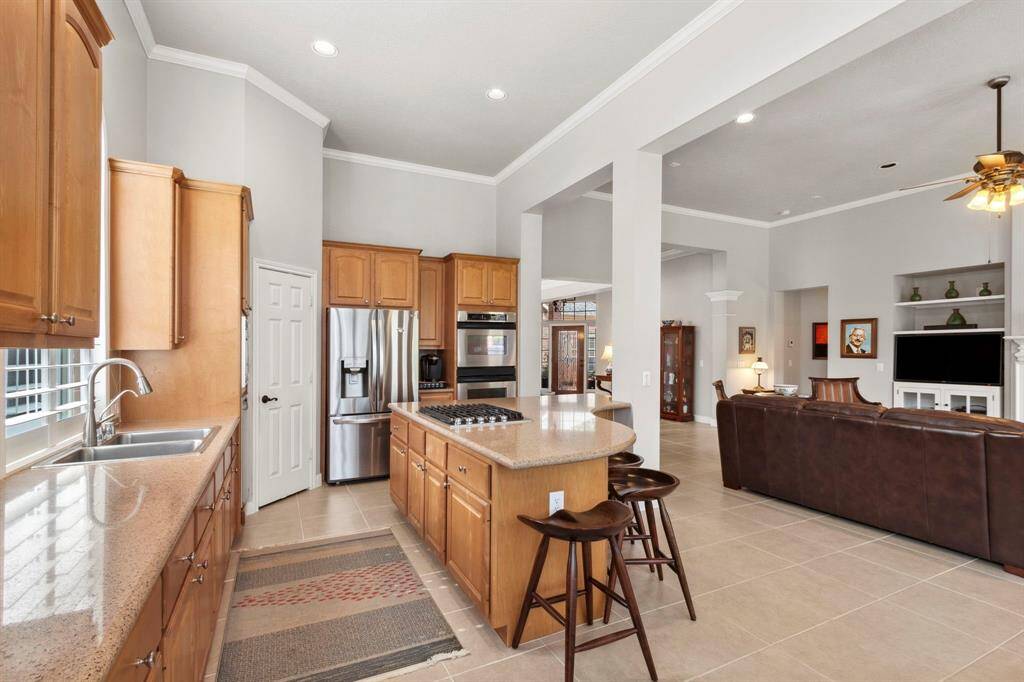 A kitchen you will want to spend time in that features stainless appliances and is open to the main areas of the home.