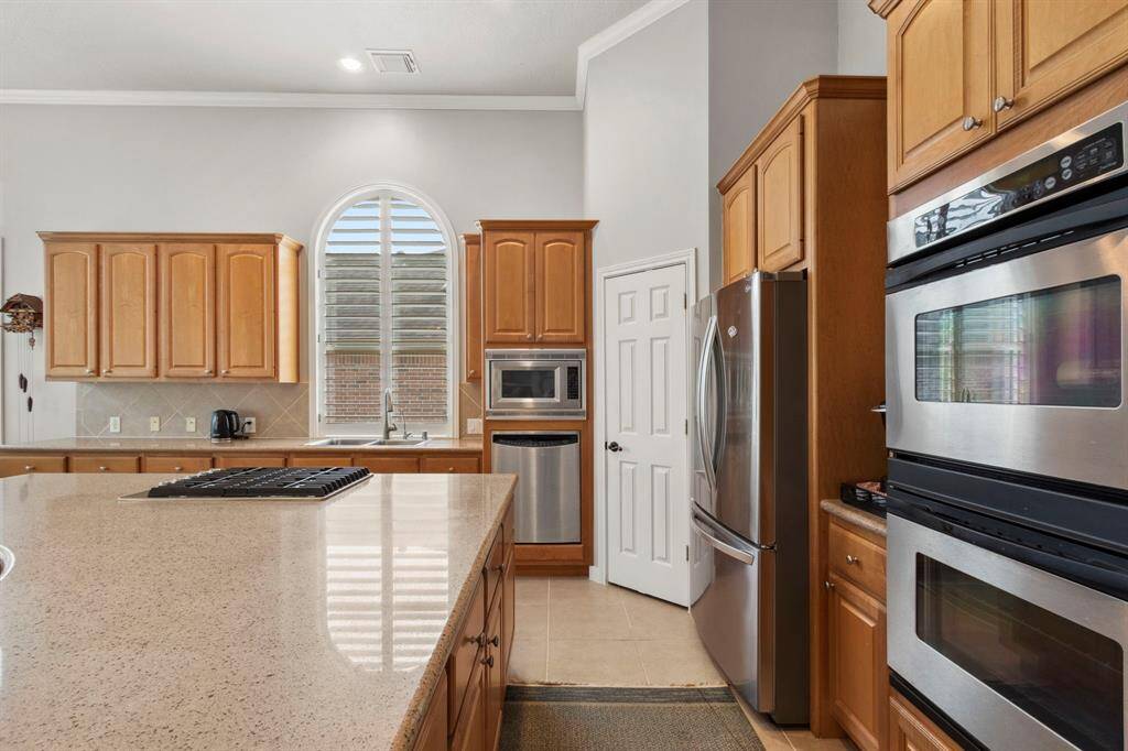 An arched window over the kitchen sink adds a beautiful touch.  The gas stove & convection oven provide a chef's touch.