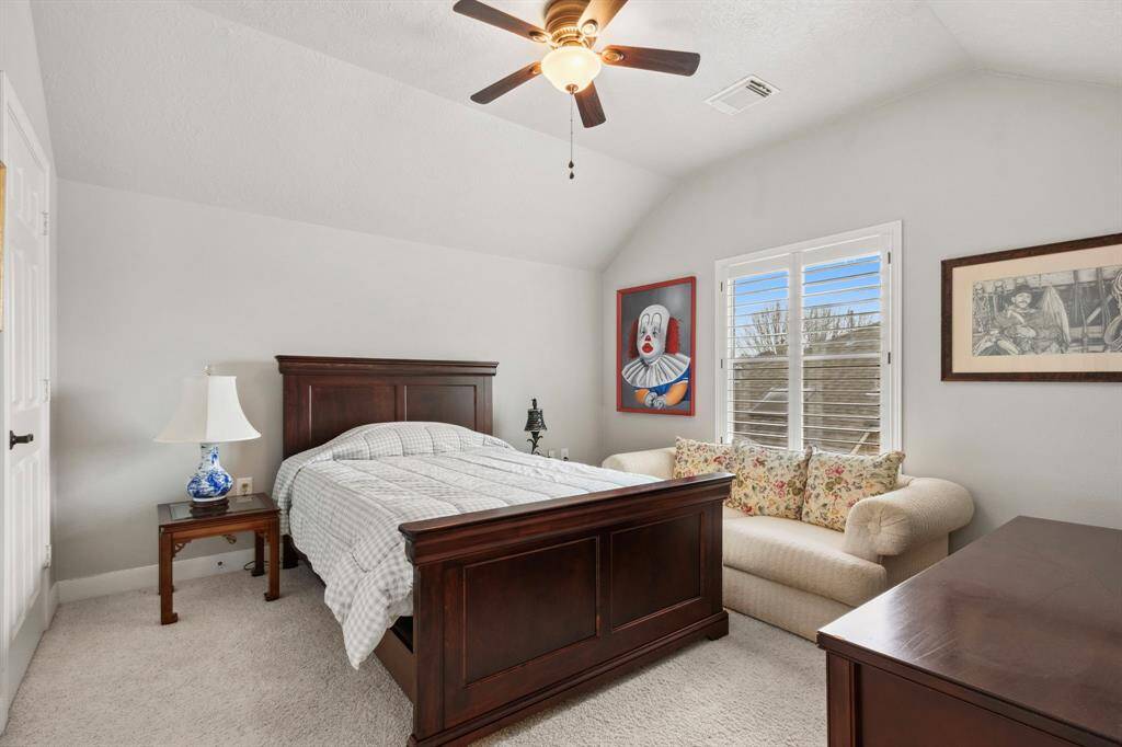 Large second bedroom upstairs in the main house with a cove ceiling detail & large closet.