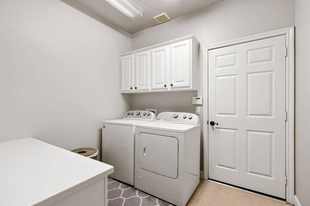 Built-in cabinetry with a separate desk area that offers a large counter space keeps things organized & neat.  The laundry room also has a door access to the garage.