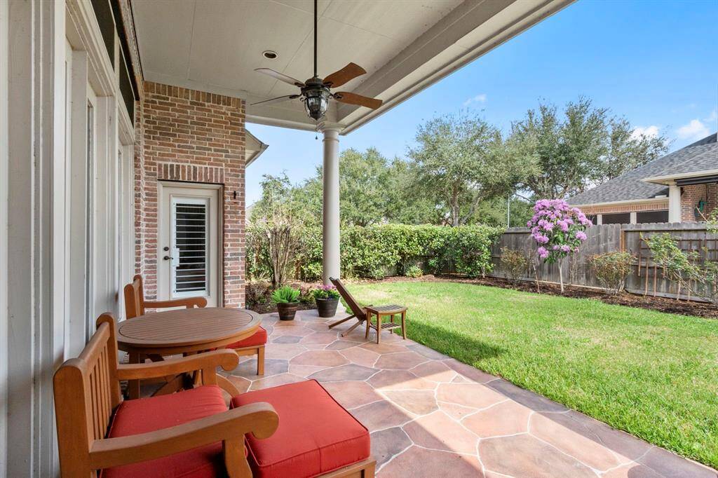 A picturesque place for morning coffee or evening cocktails.  The extended outdoor living space features high ceilings, flagstone patio & ceiling fan.