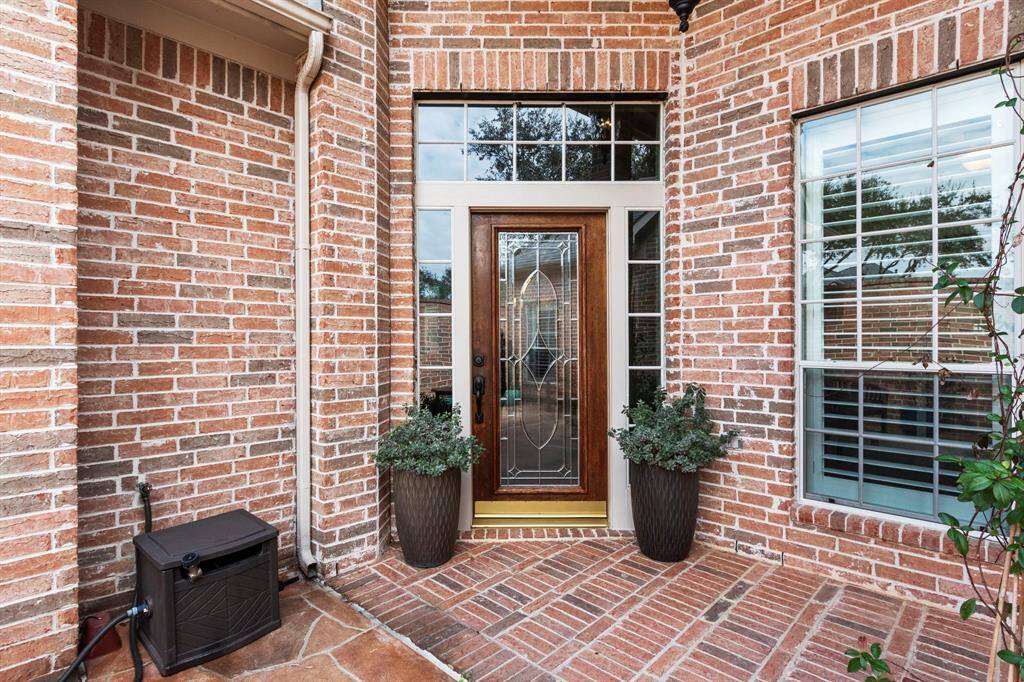 Full leaded-glass front door with side lights & transom window.