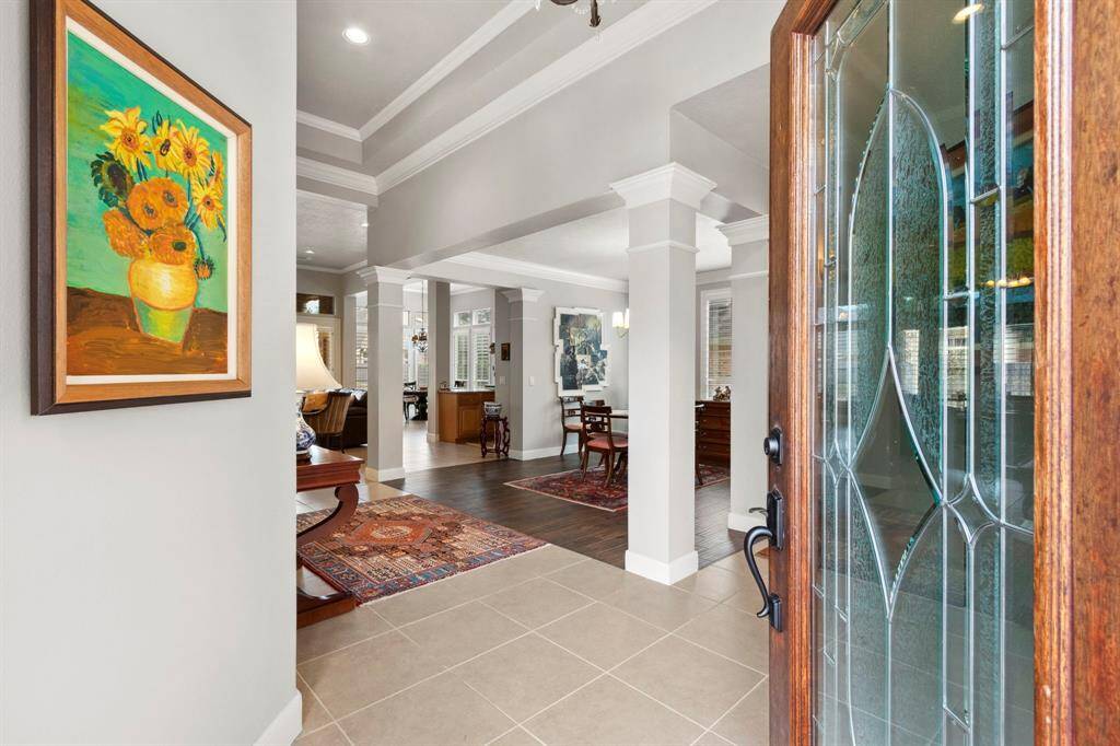 The foyer/entry opens to a view of the formal dining room & beyond to the kitchen & family room.