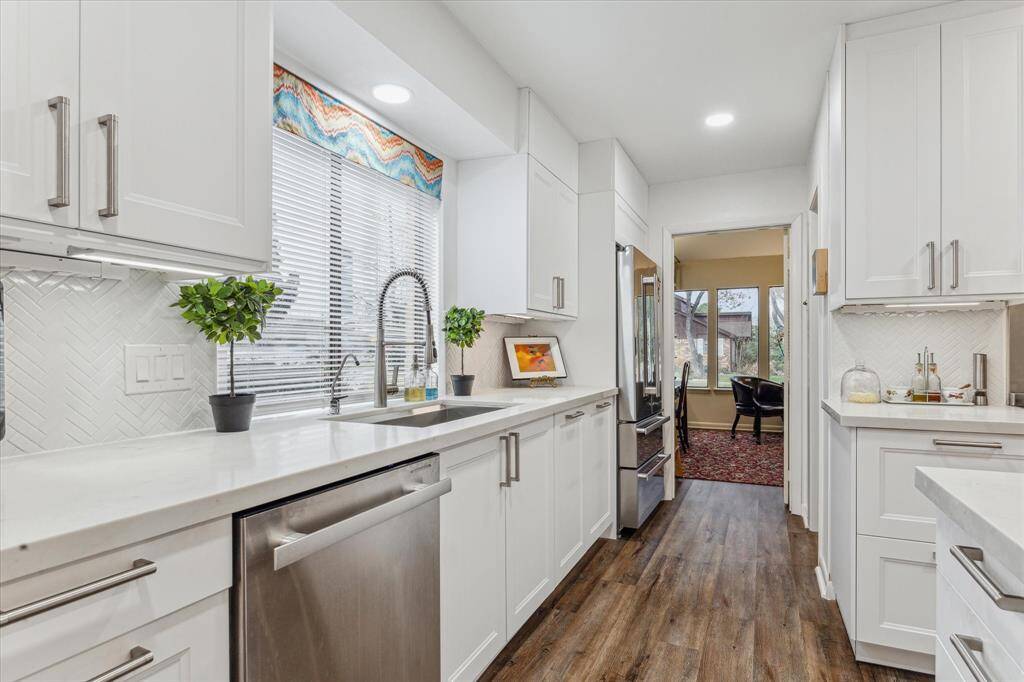 Engineered wood flooring flows throughout the kitchen, walk-in pantry, breakfast room, and library.