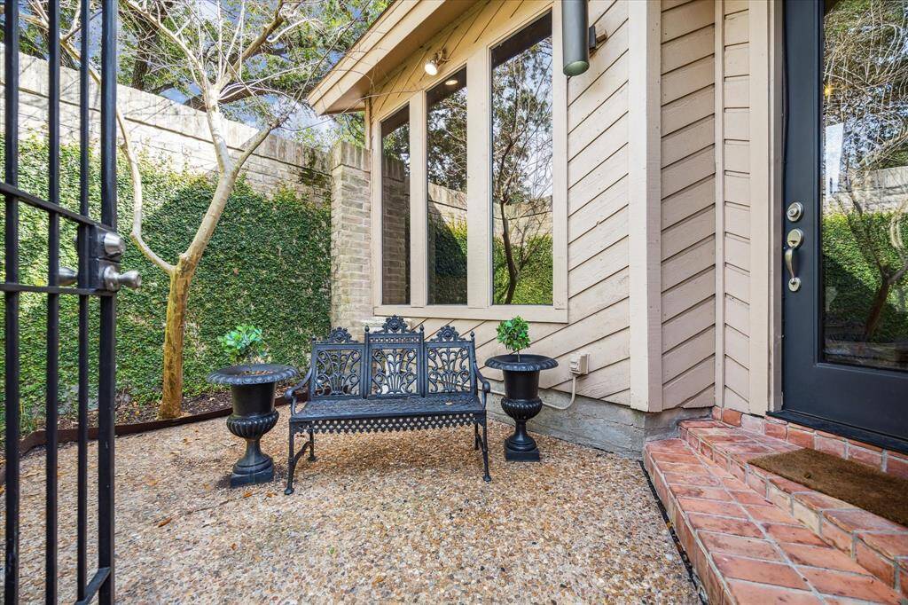 Step through the gated courtyard entry where lush greenery and a serene ambiance create the perfect welcome to this inviting home.