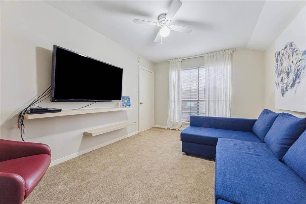 Three bedrooms are located upstairs and feature carpet flooring, and generous closets. This room is currently used as a TV room.