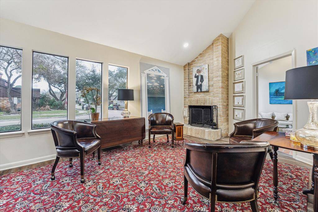 Thoughtfully designed with a wall of custom shelving, a built-in sideboard, and engineered wood flooring, it offers both function and charm. With direct access to the kitchen, this space could easily serve as a formal dining room, perfect for entertaining or quiet evenings by the fire.