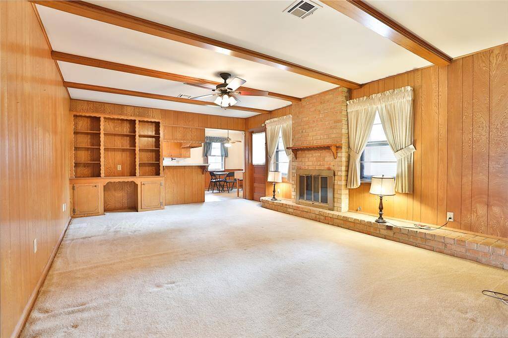 Expansive den with faux ceiling beams.  Great possibilities for this room!