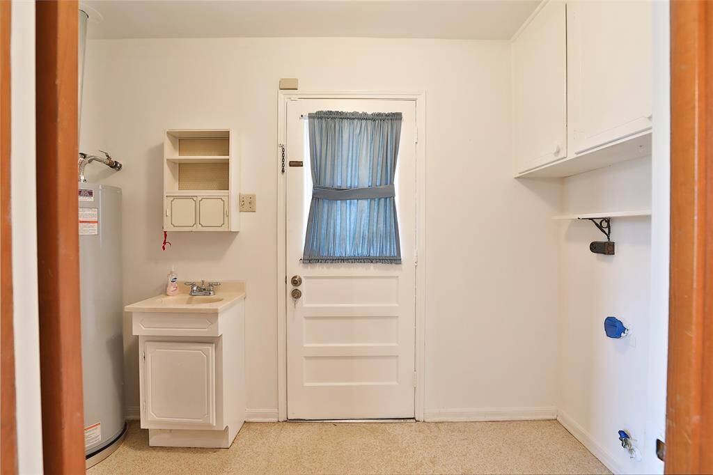 Utility room with access to the back yard.  Separate sink for easy clean up when working outside!