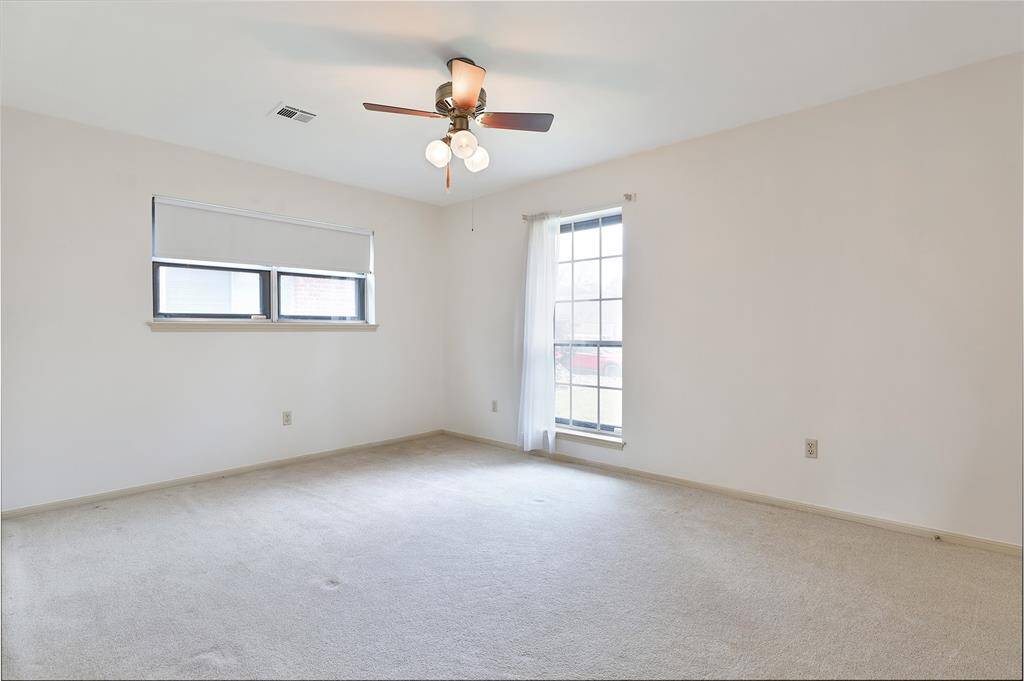 Front bedroom.  All bedrooms have carpet and ceiling fans.