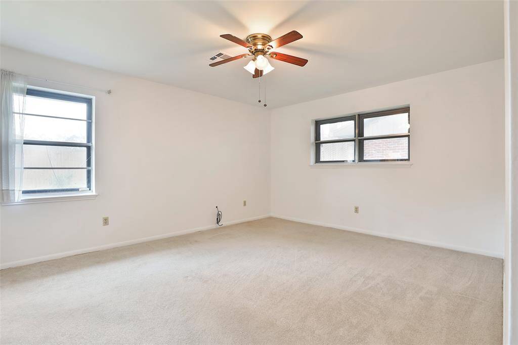 Primary bedroom.  Again, ceiling fans and carpet.