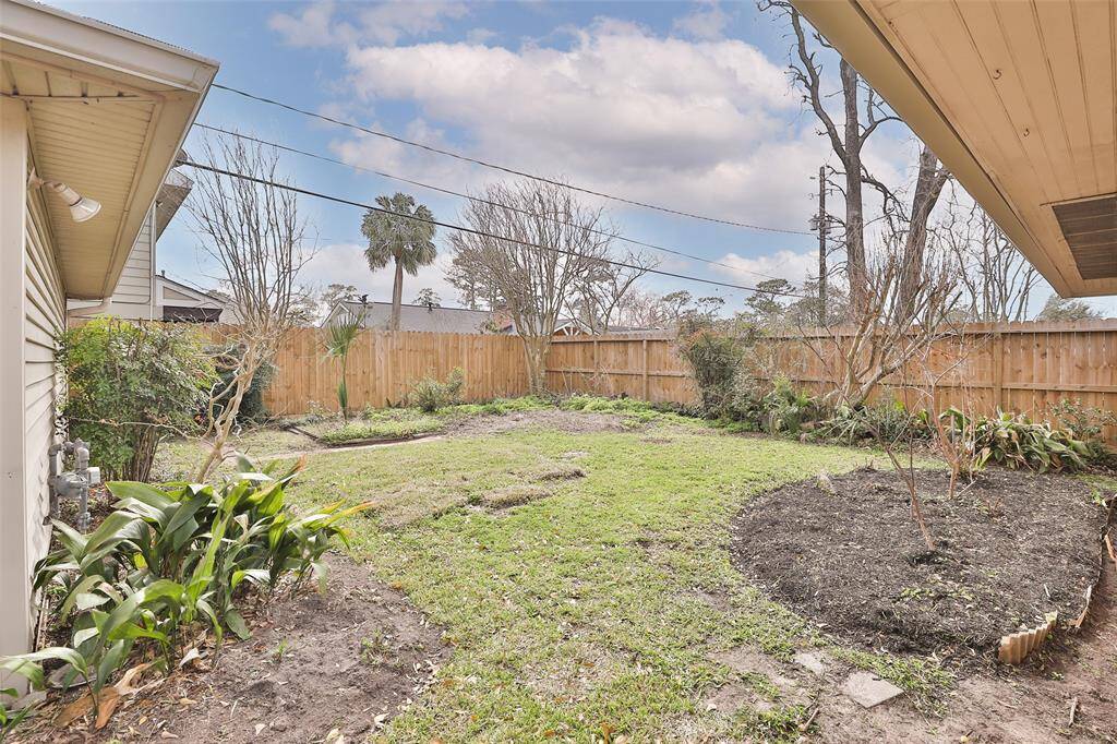 View of your backyard as seen from the house.  Owner has planted new grass.  Endless possibilities for this green space!